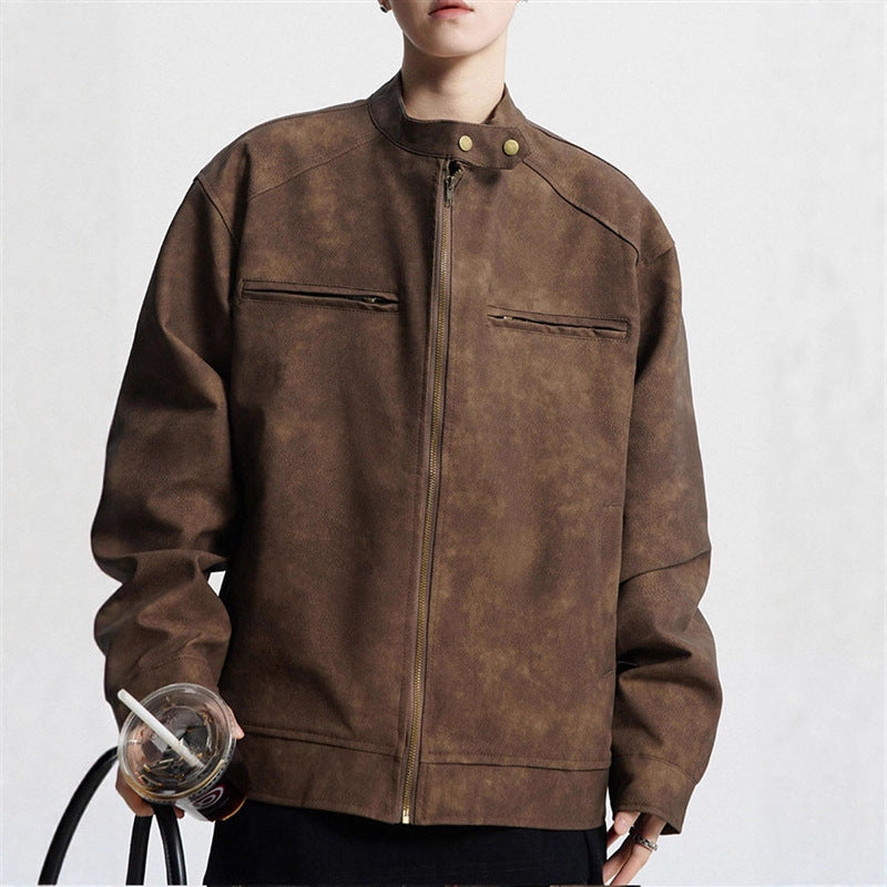 Person wearing brown suede zip-up jacket with stand collar holding drink cup