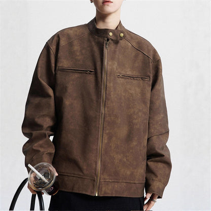 Person wearing brown suede zip-up jacket with stand collar holding drink cup