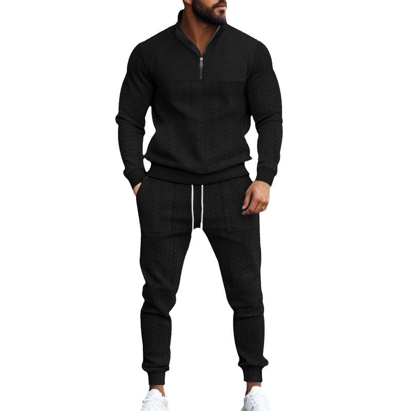 Man wearing black textured knit zip-up sweatshirt and matching jogger pants with white drawstrings