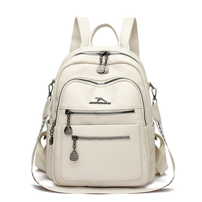 White leather backpack with multiple zipped compartments and adjustable straps on white background