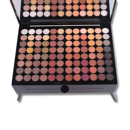 open makeup palette with varied eyeshadow and blush shades in warm and neutral tones with built-in mirror
