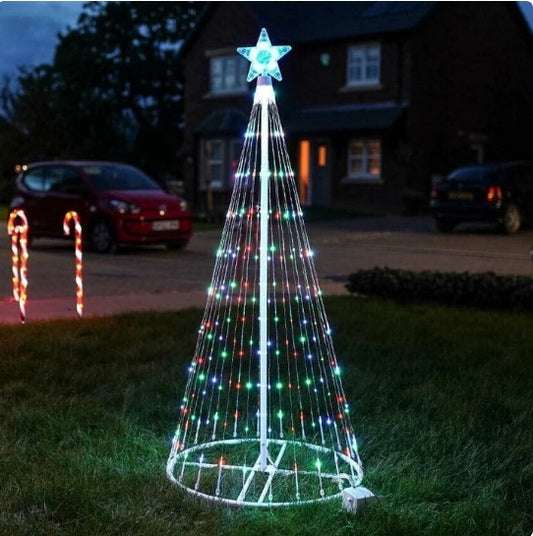 Outdoor LED Christmas tree lights in multi-color with a star topper on lawn at night