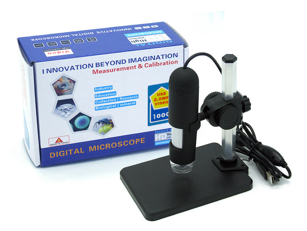 USB digital microscope with 1000x magnification and LED illumination on black stand next to product box