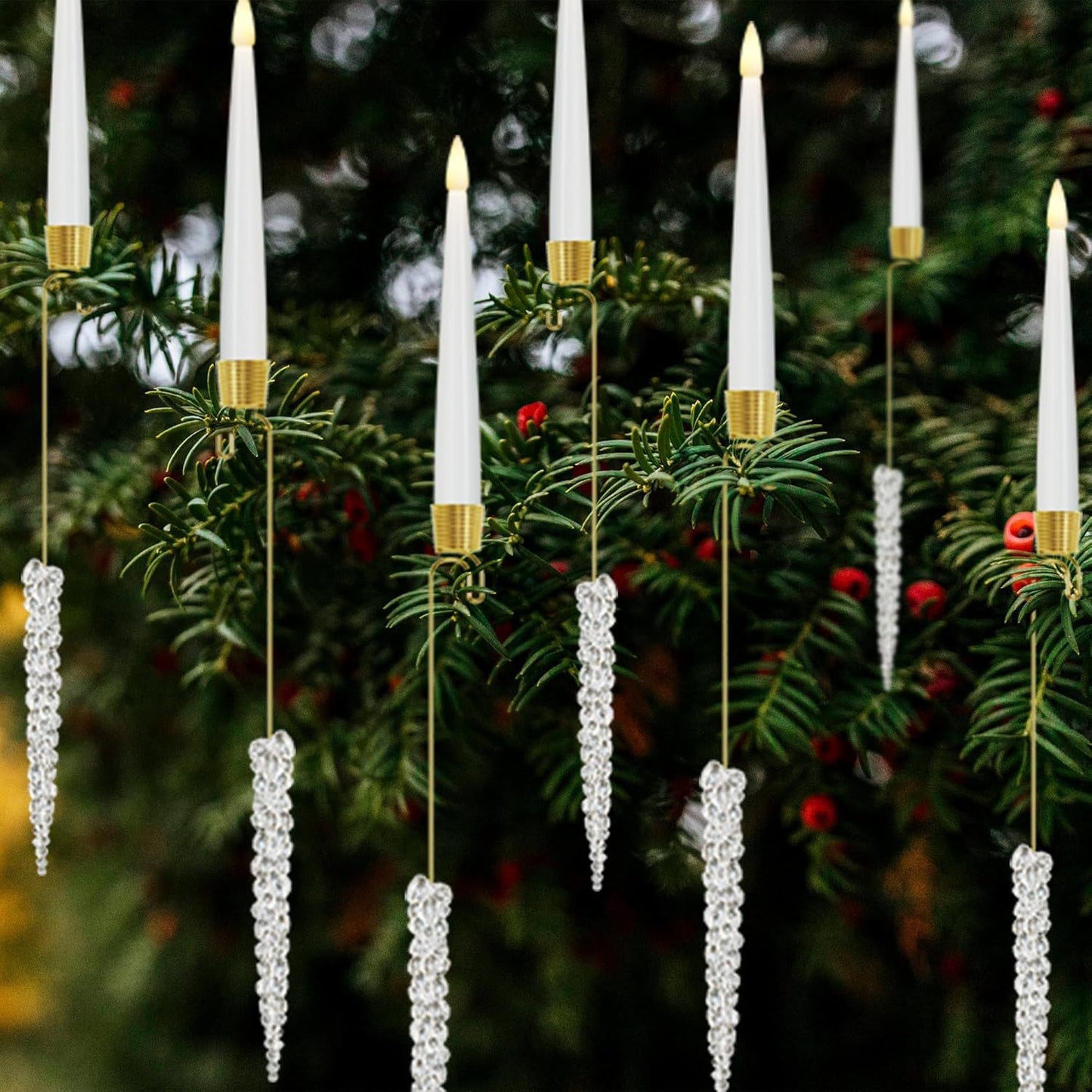 Christmas tree branch decorated with white LED candle ornaments and hanging crystal icicles