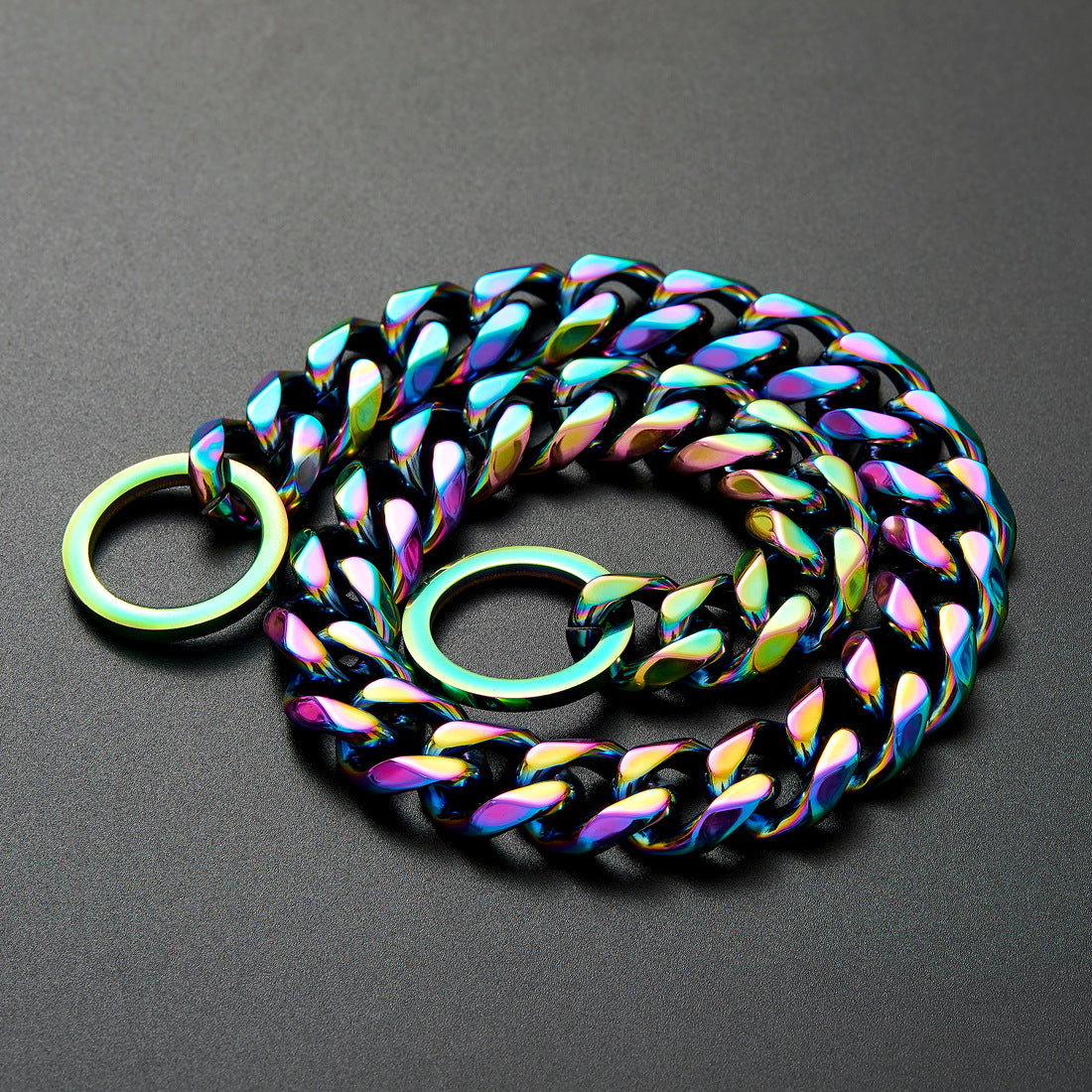 Rainbow-colored stainless steel dog collar chain with round metal rings on dark background