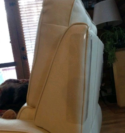 Beige leather sofa armrest with clear PVC cat claw protector against scratches in living room