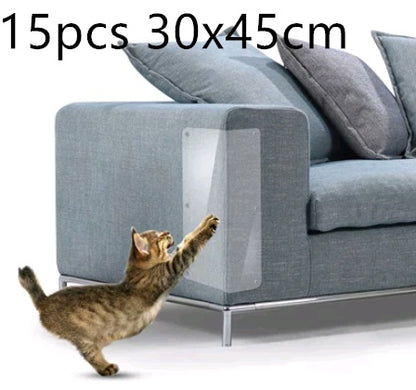 Tabby cat reaching toward clear PVC sofa protector on grey fabric armrest
