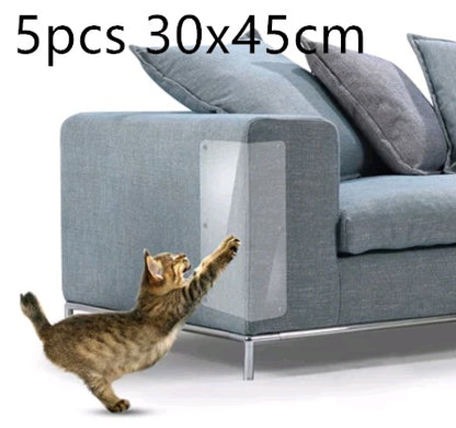 Cat reaching paw towards clear PVC sofa protector on grey upholstered sofa armrest