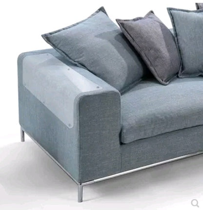 Modern grey fabric sofa with clear PVC cat claw protector on armrest to prevent furniture scratches