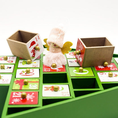 Wooden Christmas advent calendar with numbered drawers and a small angel figurine on green base