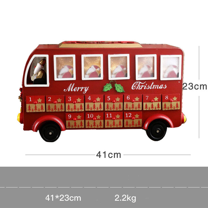 Red wooden Christmas advent calendar shaped like a bus with numbered drawers and Santa figure