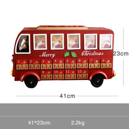 Red wooden Christmas advent calendar shaped like a bus with numbered drawers and Santa figure
