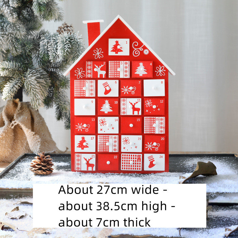 Red and white wooden Christmas advent calendar shaped like a house with festive holiday designs