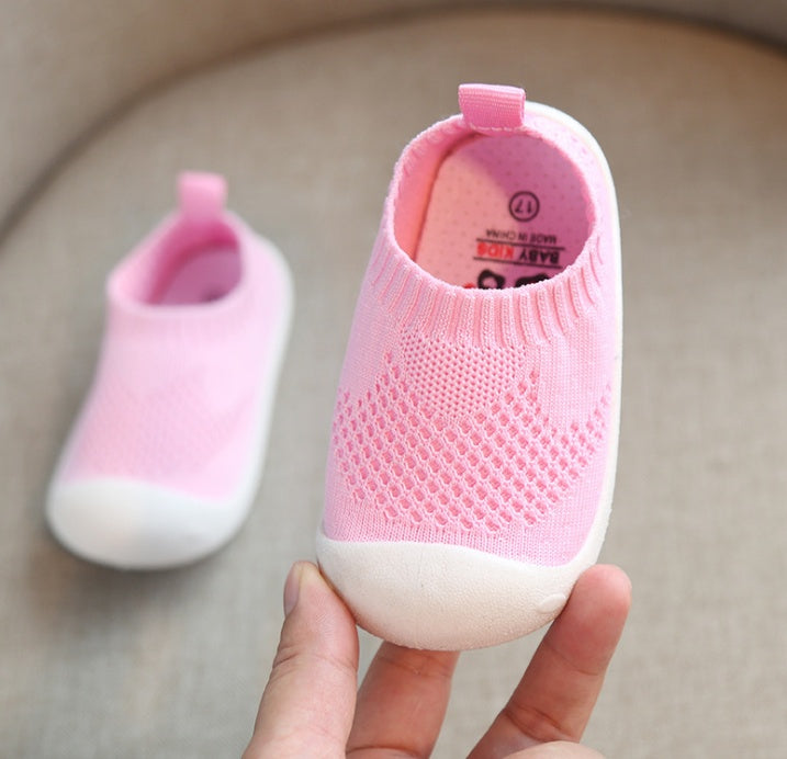 Soft pink toddler slip-on shoes with breathable cotton knit and flexible white sole
