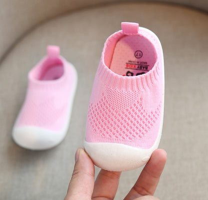 Soft pink toddler slip-on shoes with breathable cotton knit and flexible white sole