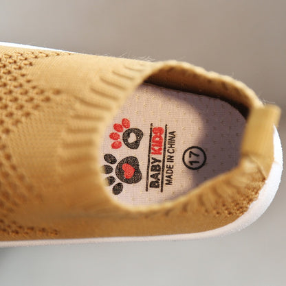 Close-up of brown toddler slip-on shoe with breathable knit upper and white sole, size 17
