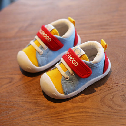Colorful toddler slip-on shoes with soft sole, breathable cotton, flexible fit, on wooden surface