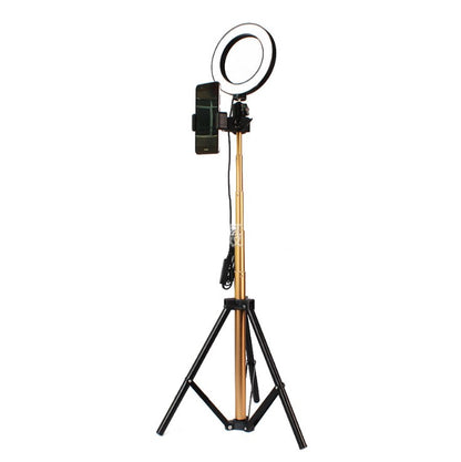 gold ring light with black tripod stand and smartphone holder on white background