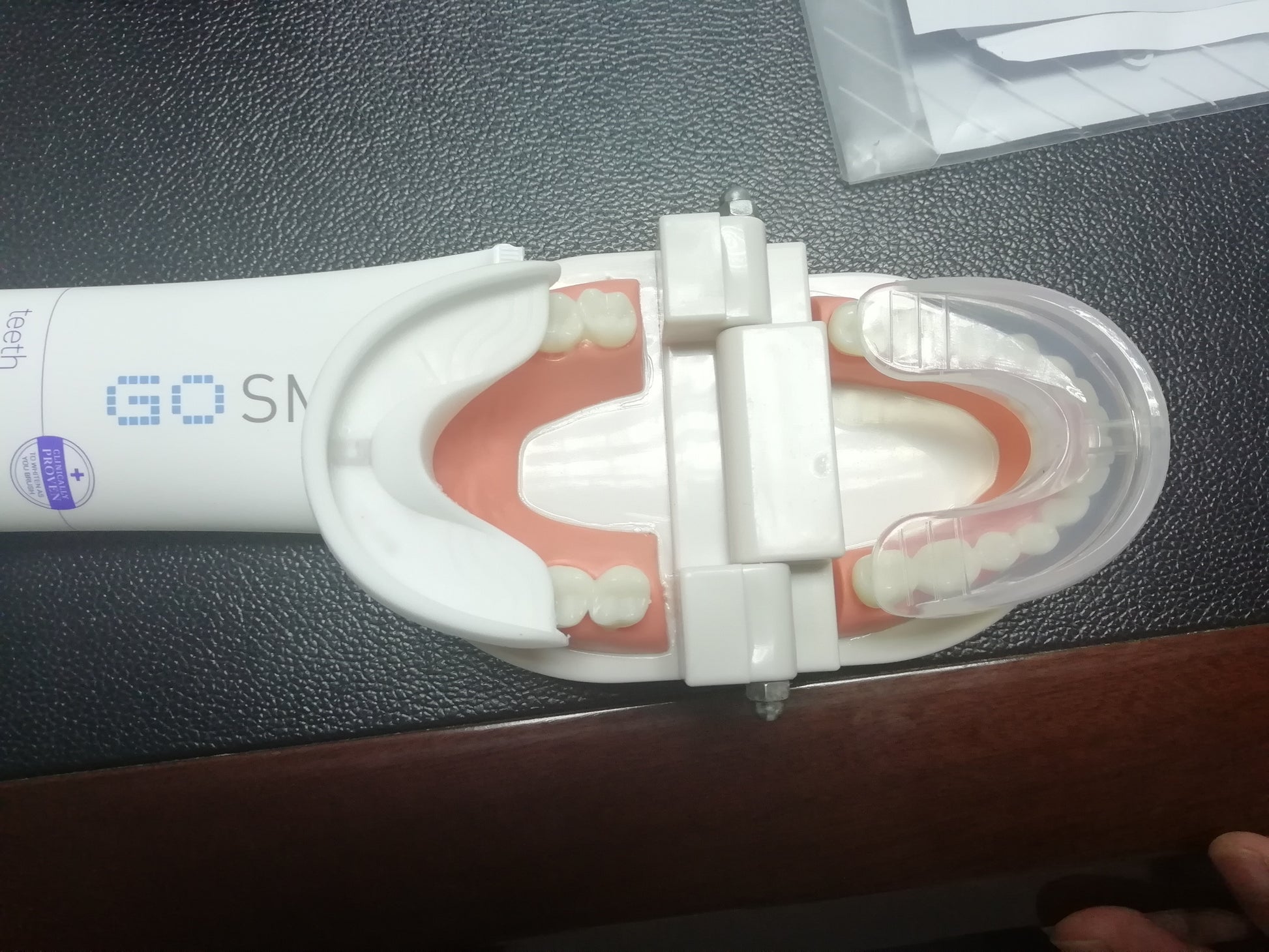 white GoSmile automatic electric toothbrush with a dental model showing teeth and 360-degree mouth guard