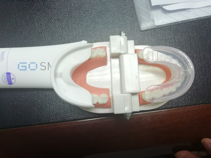 white GoSmile automatic electric toothbrush with a dental model showing teeth and 360-degree mouth guard