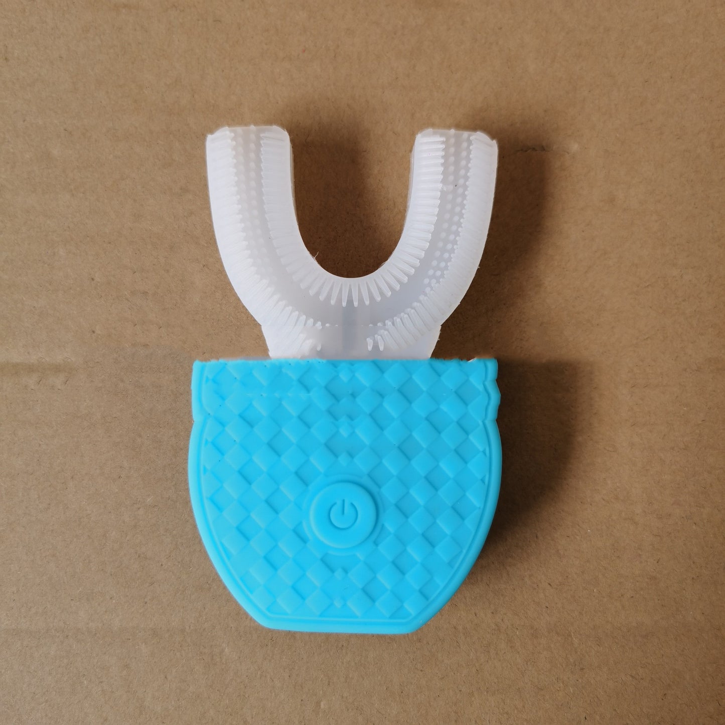 Blue and white U-shaped automatic electric toothbrush with power button on beige background