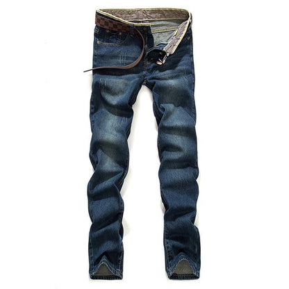 Men's slim fit blue denim jeans with tapered legs and brown leather belt on white background