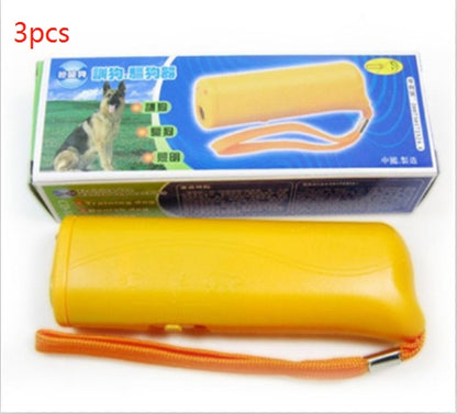 Yellow ultrasonic dog repeller with orange wrist strap and packaging box featuring dog image and Chinese text