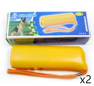 Yellow ultrasonic dog repeller device with orange wrist strap beside blue and white box featuring a dog image