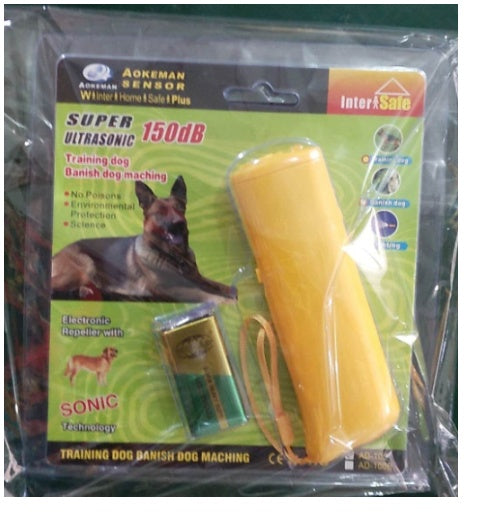 Yellow ultrasonic dog repeller with LED flashlight and 9V battery in retail packaging for dog training
