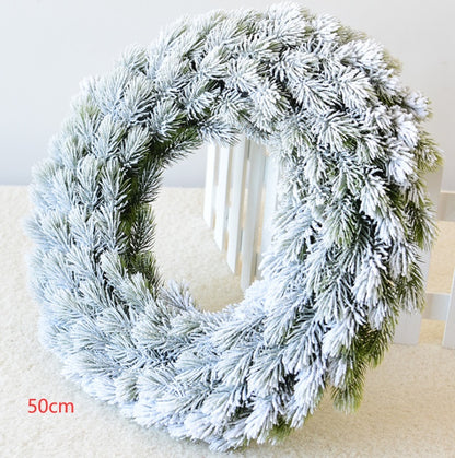 50cm snowflake pine cone Christmas wreath with frosted green pine branches on white carpet