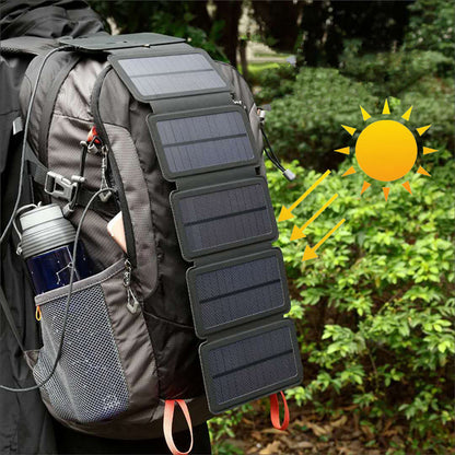 Foldable portable solar charger attached to hiking backpack in outdoor setting with sunlight