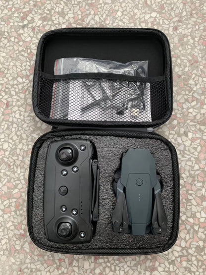 Compact black quadcopter drone and remote control stored in portable black foam case on terrazzo floor