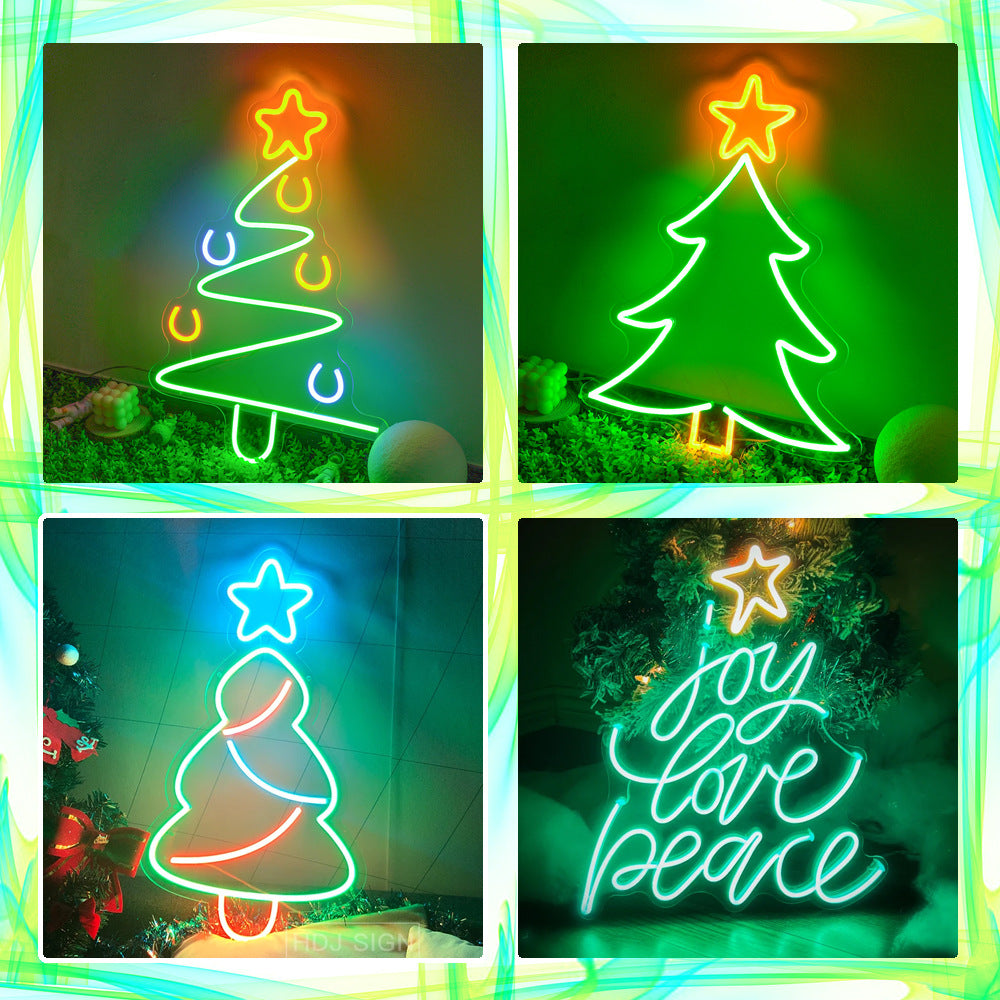 Four neon Christmas tree signs with stars and holiday messages in green, red, blue, and orange lights