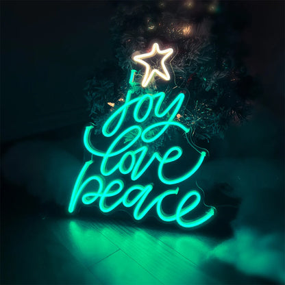 Neon Christmas tree sign with glowing star and words joy love peace in teal and white lights