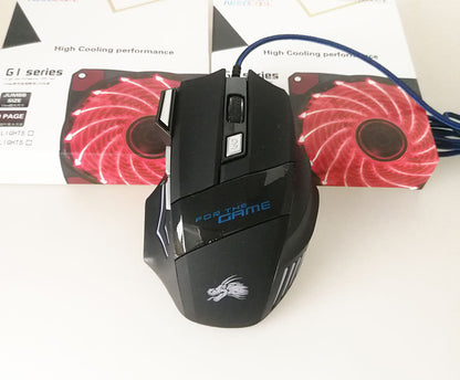 Black wired gaming mouse with blue text 'FOR THE GAME' and dragon logo on white surface, red LED computer fans in background