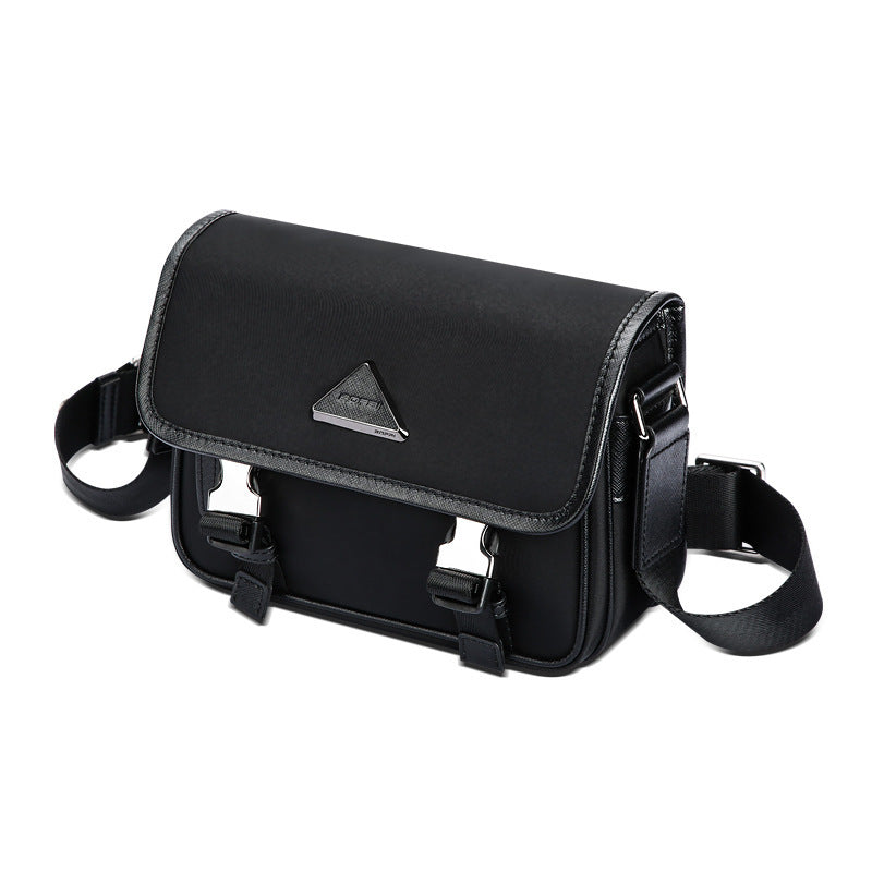 Black nylon messenger bag with adjustable shoulder strap and silver triangle logo on front flap