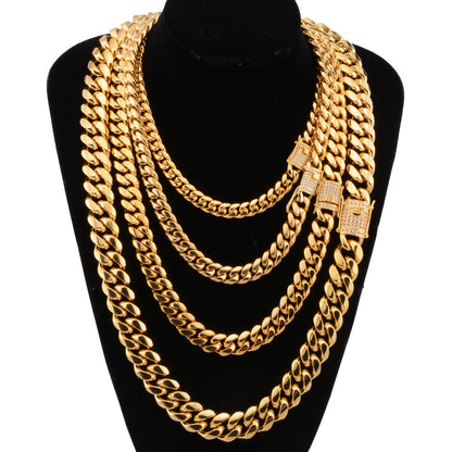 Set of chunky gold Cuban link chains in varied thicknesses displayed on black velvet bust