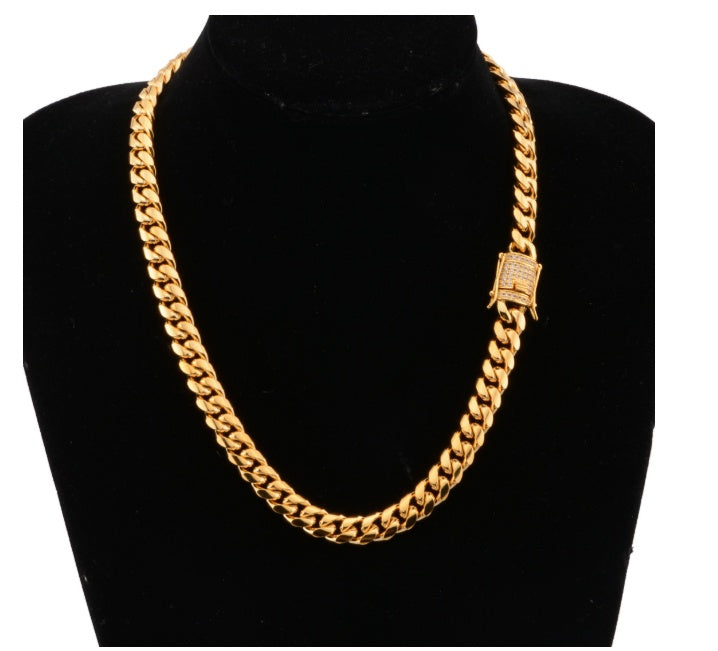 Chunky gold Cuban link chain necklace displayed on black velvet bust