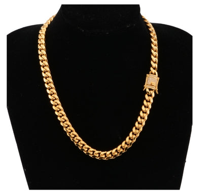 Chunky gold Cuban link chain necklace displayed on black velvet bust