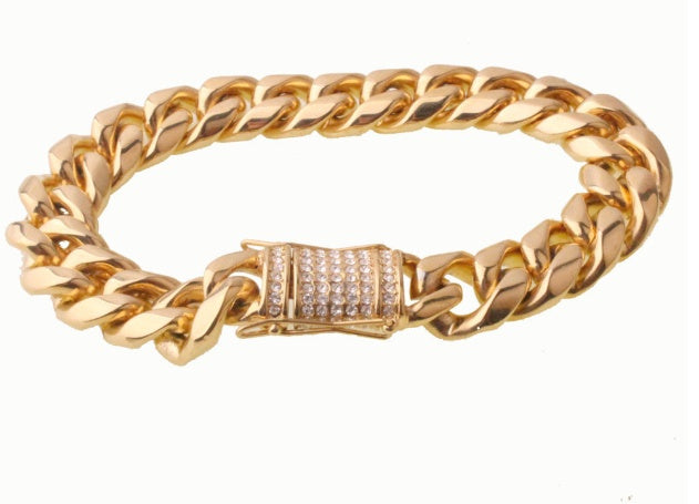 Chunky gold Cuban chain necklace with rhinestone-studded clasp on white background