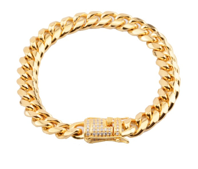 Chunky gold Cuban link chain necklace with diamond-studded clasp on white background