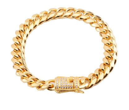 Chunky gold Cuban link chain necklace with diamond-studded clasp on white background