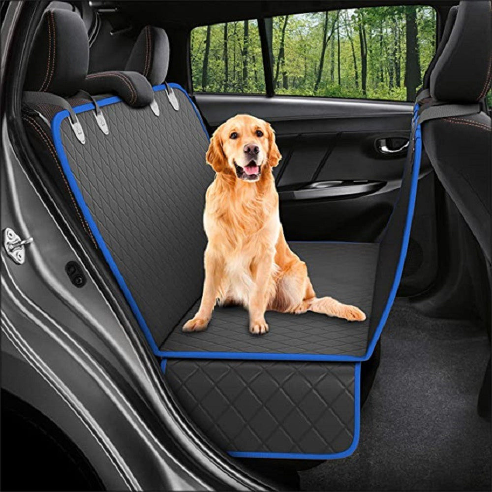 Golden retriever sitting on black and blue waterproof dog car seat cover hammock in car backseat