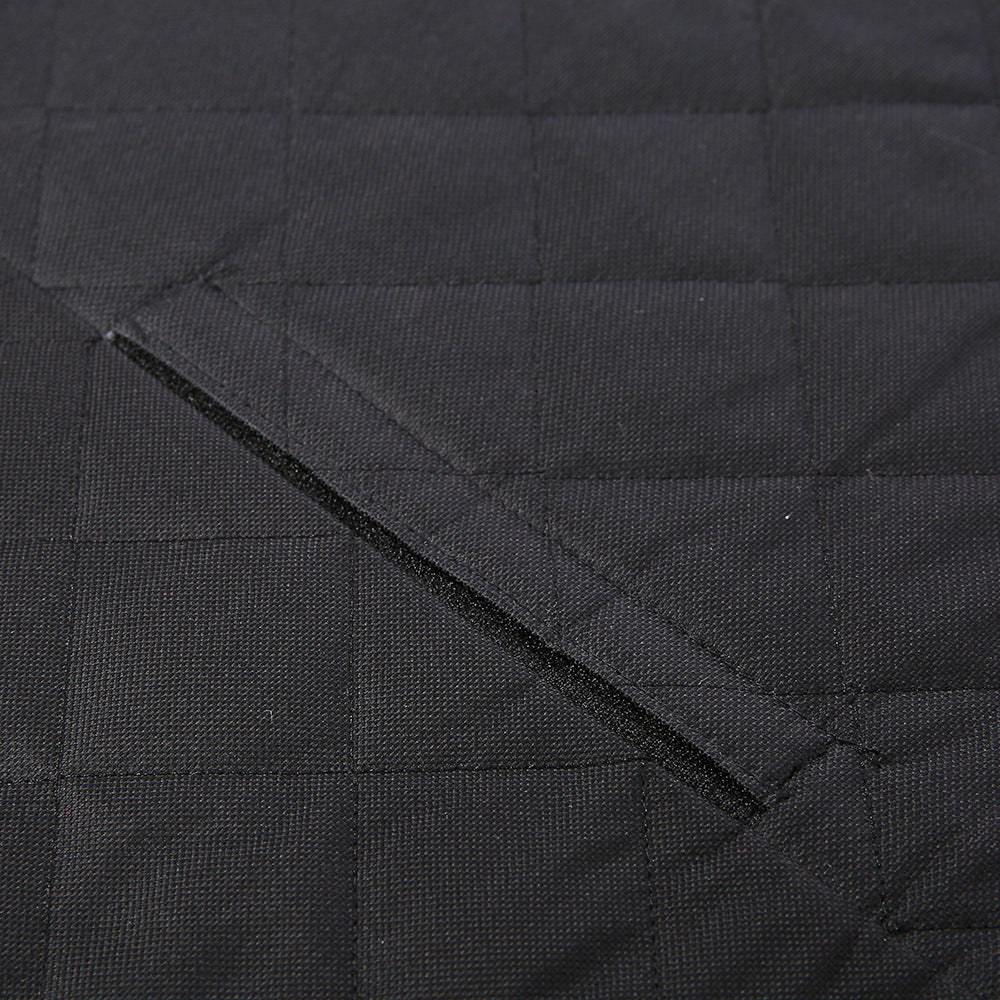 Close-up of black waterproof quilted fabric with a diagonal stitched slit or opening