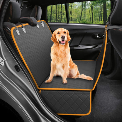 Golden retriever sitting on black quilted waterproof dog car seat cover with orange trim in car backseat
