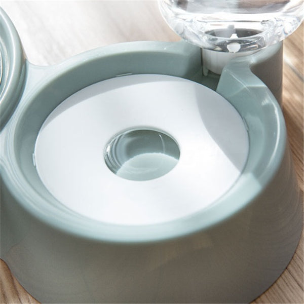 close-up of a gray automatic dog water bowl with built-in water dispenser on wooden floor
