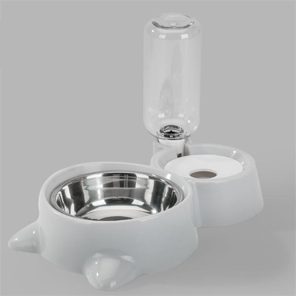 Pink automatic dog bowl with stainless steel water dispenser and ball refill system on gray background