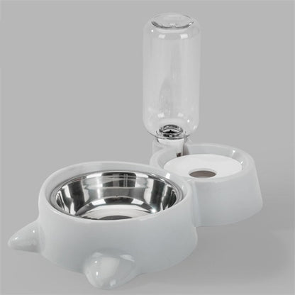 Pink automatic dog bowl with stainless steel water dispenser and ball refill system on gray background