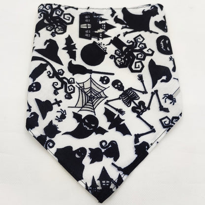 Black and white Halloween dog bandana with ghosts, skeletons, bats, witches, spider webs, and haunted houses