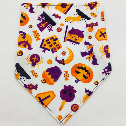 Halloween-themed pet bandana with pumpkins, bats, tombstones, spiders, and candy on white fabric